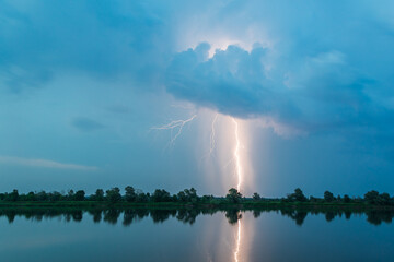 Bright flash of lightning over the river