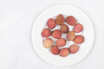 Lychee fruit isolated above white background