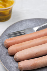 Cooked Frankfurters served on the plate for the breakfast