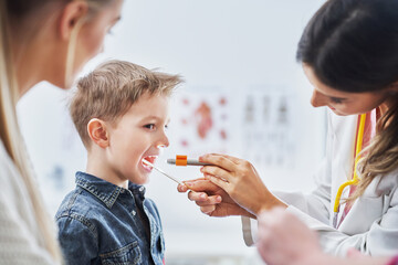 Little boy having medical examination by pediatrician