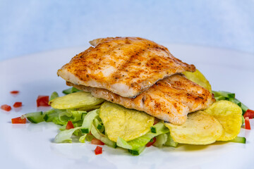 Grilled zander with potatoes and vegetables.  Food styling for street food. Closeup.