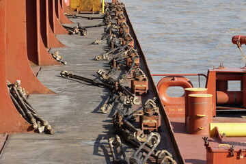 Lashing material, bottom twist-locks and turnbuckles for securing containers on the container...