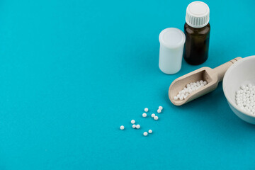 Homeopathy alternative medicine eco concept - classical homeopathy pills. Homeopathic globules on blue background. 