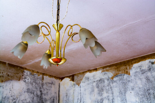 Old chandelier in a run-down flat of a panel house
