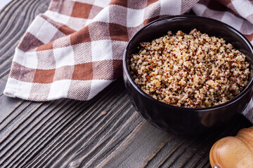 bowl of healthy quinoa on a dark wooden rustic background