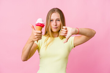 Young russian woman eating an ice cream isolated showing thumbs up and thumbs down, difficult choose concept