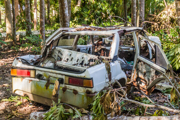 Old rusty car in a forest near Loboc village on Bohol island, Philippines
