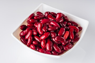 canned red kidney beans on a white acrylic background
