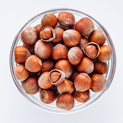 fresh natural hazelnuts on a white acrylic background