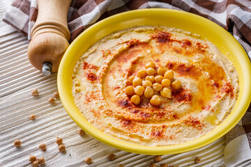 traditional turkish hummus on a white wooden rustic background