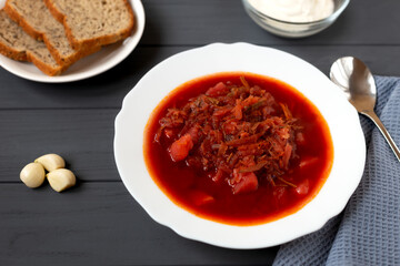 Borscht in a plate on a gray background