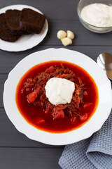Borscht in a plate on a gray background