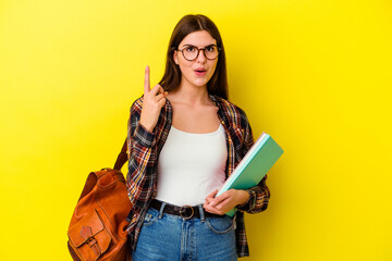 Young student woman isolated on yellow background having some great idea, concept of creativity.