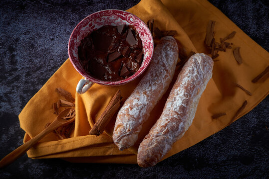 Fartons, typical pastries from Valencia, Spain, with hot chocolate. A sweet breakfast or snack.