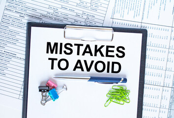 Text Mistakes To Avoid on the folder that is located on the financial reports with calculator and...