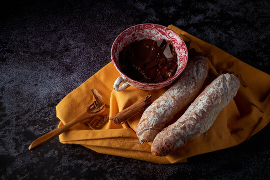 Fartons, typical pastries from Valencia, Spain, with hot chocolate. A sweet breakfast or snack.