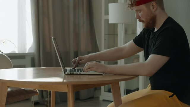 CRASH ZOOM IN Funny Caucasian male furiously pushing buttons on a laptop keyboard