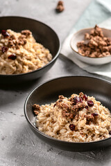 Fresh oatmeal with granola, syrup and nuts