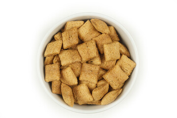 Chocolate breakfast pillows, in a white bowl on a white background. Top view