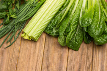 Fresh green romaine lettuce leaves. Mint sprigs, green onions and celery stems