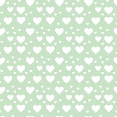 Colorful seamless pattern with hearth symbol and pastel green background