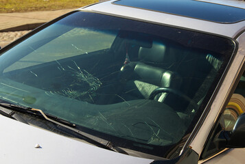 Broken windshield of a car after an accident.