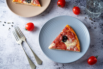 Pizza with pepperoni, tomato sauce and cheese