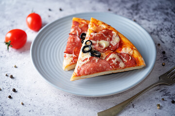 Pizza with pepperoni, tomato sauce and cheese