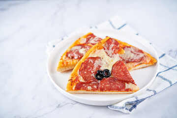 Pizza with pepperoni, tomato sauce and cheese