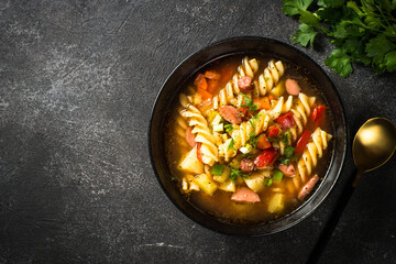 Vegetable soup with pasta and sausages.