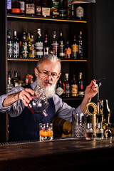 Portrait elderly bartender man with fresh delicious cocktail