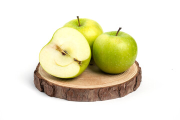Three fresh whole and sliced apples on wooden piece
