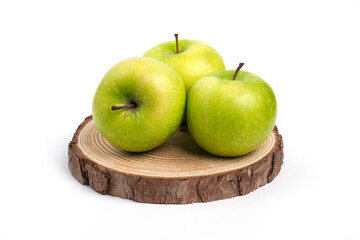 Three fresh whole and sliced apples on wooden piece