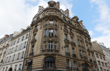 Traditional French house with typical balconies and windows. Paris .