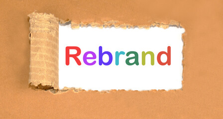 rebrand lettering on torn cardboard. Marketing concept