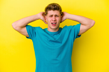 Fototapeta na wymiar Young caucasian man isolated on yellow background screaming with rage.