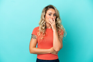 Young Brazilian woman isolated on blue background surprised and shocked while looking right