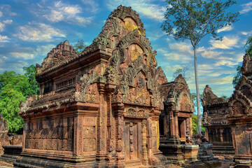 Fototapeta na wymiar Banteay Srei - Cambodian temple dedicated to the Hindu god Shiva.Ancient Khmer ruins in the jungle.Red sandstone monument. Monkey Guard Statues.The walls are decorated with highly detailed bas-reliefs