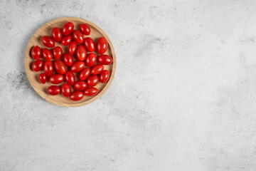 Bunch of fresh tomatoes on wooden plate