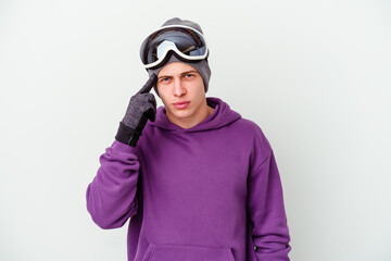 Young man holding a snowboard board isolated on white background pointing temple with finger, thinking, focused on a task.