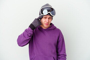 Young man holding a snowboard board isolated on white background showing a disappointment gesture with forefinger.