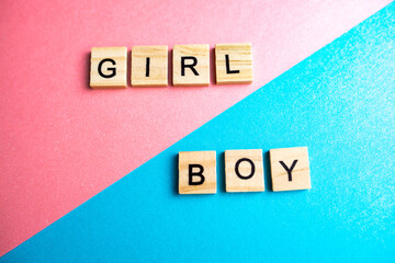 blocks of the alphabet with letters on a double background pink and blue. lettering boy and girl on blue and pink sheet of paper