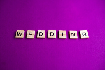 alphabet blocks with letters on a pink background. inscription WEDDING