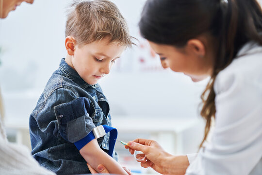 Little boy having blood sample drawn in a lab