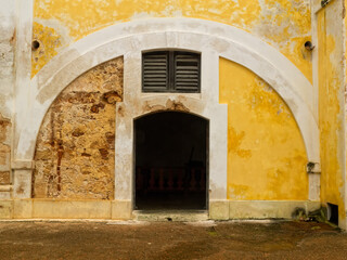 Colorful worn and weathered arched doorway inside an old Fort in San Juan Puerto Rico