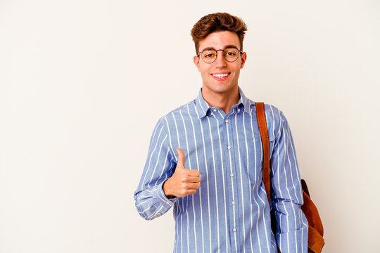Young student man isolated on white background smiling and raising thumb up