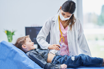 Little boy having USG examination by pediatrician - Powered by Adobe