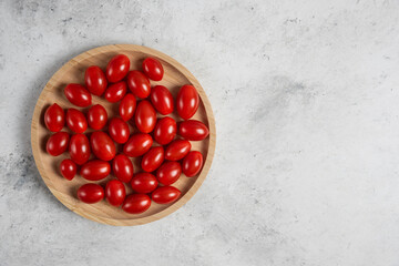 Bunch of cherry tomatoes on wooden plate
