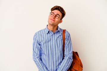 Young student man isolated on white background dreaming of achieving goals and purposes