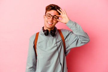 Obraz premium Young student man isolated on pink background excited keeping ok gesture on eye.